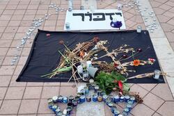 Candles and Yizkor sign remembering Oct 7