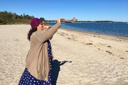 Rabbi Minna Bromberg Blowing a Shofar on the Beach