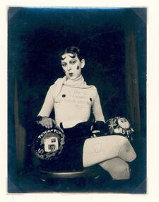 Black and white photograph of a gender-nonconfirming individual wearing boxing gloves