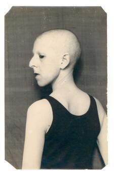 black and white photograph in profile of a figure with a shaved head