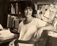 black and white photograph of a woman at a typewriter