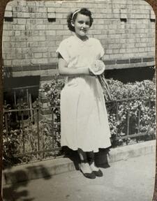 Black and white photograph of a teenage girl in a white dress