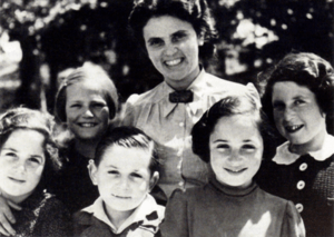 Andree Salom smiling with five young children