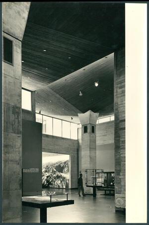 A large, open room with columns and glass exhibit cases