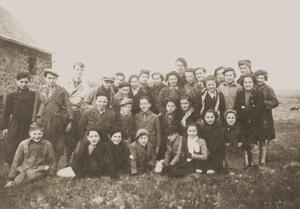 A group of school-age children standing together outdoors