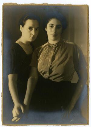 Hilda Purwitsky and Roza Van Gelderen looking to camera with hands touching