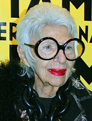Iris Apfel smiling wearing black top and round black glasses at MIFF 2015