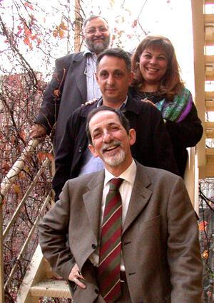 Four founders of Los Pasharos Sefaradis posed on steps. Front to back: Izzet Bana, Yavuz Hubes, Karen Gerson Sarhon, and Selim Hubes