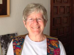 Martha Ackelsberg from the chest up smiling to the camera