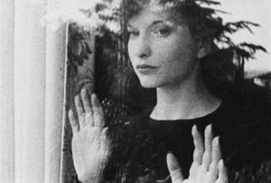 Still of  Maya Deren looking out of a window from the 1943 short film Meshes of the Afternoon