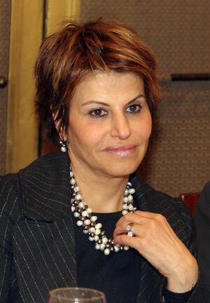 image of a woman with short brown hair in a black suit