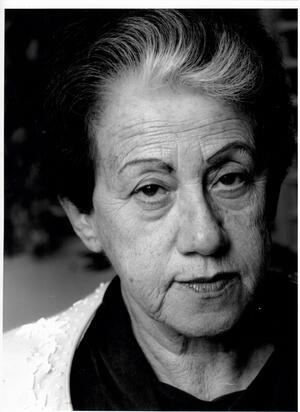 Black and white photograph of a woman with dark hair with a white streak in front