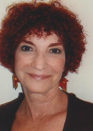 photograph of a woman with short curly red hair