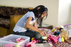 Girl Playing with Barbies, 2012