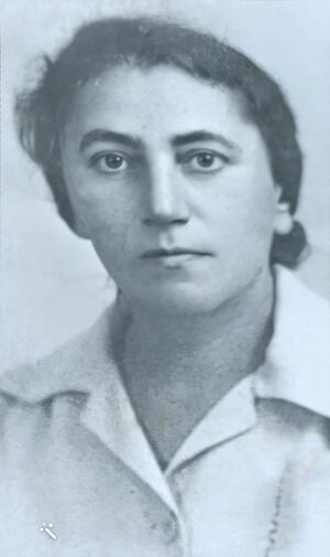 black and white photograph of a woman with dark hair pulled back, looking seriously at the camera
