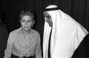 black and white photograph of a woman and a man wearing an Arab head covering