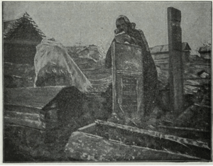 black and white photograph of a woman measuring a grave in Russia