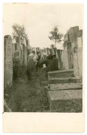 black and white historical photograph of professional mourning women in a cemetery