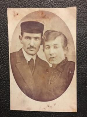 black and white photograph of a man in a hat and a woman