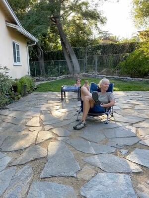 Woman sitting in lounge chair on patio