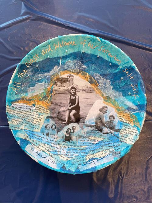 Plate with blue tissue paper, black and white portraits, and text