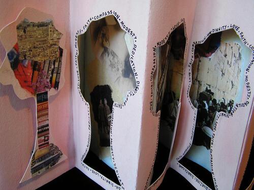 Close up of an accordian-folded book form with tree-shaped cutouts 