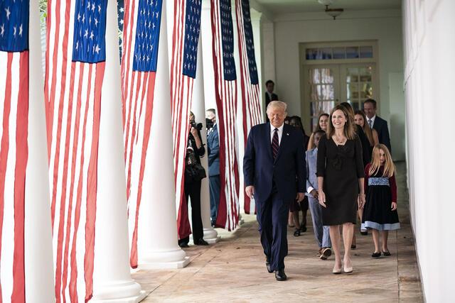 Donald Trump walks with Amy Coney Barrett