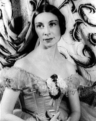 A portrait of Alicia Markova wearing a ballet costume, with an off-shoulder neckline decorated with flowers