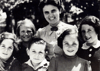 Andree Salom smiling with five young children