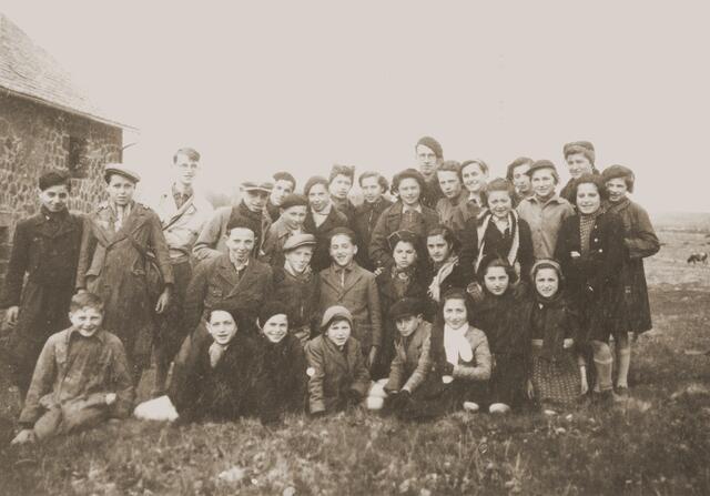 A group of school-age children standing together outdoors
