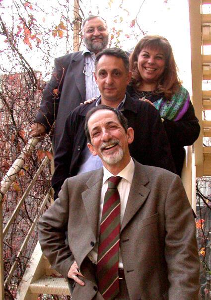 Four founders of Los Pasharos Sefaradis posed on steps. Front to back: Izzet Bana, Yavuz Hubes, Karen Gerson Sarhon, and Selim Hubes