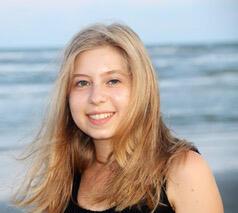 Photo of Madeline Canfield, the beach in the background.