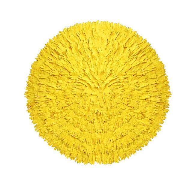 A large circle composed of yellow gloves, overlapped, with fingers facing out