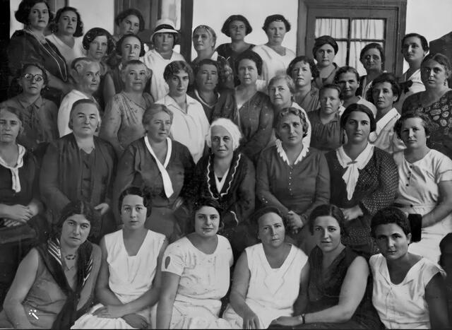 black and white historical photo of a large group of women