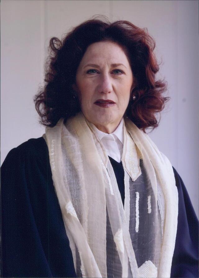 photographr of a woman wearing cantorial robes and a tallit