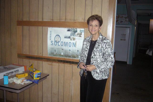 Carol Wise Beside JWA Poster in the Abandoned Congregation Beth Israel in Biloxi, June 21, 2007