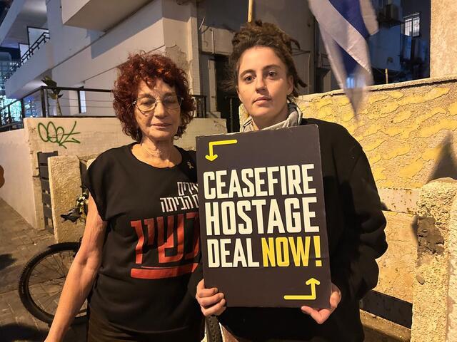 photograph of two women demonstrating with a sign "Ceasefire Hostage Deal Now!"