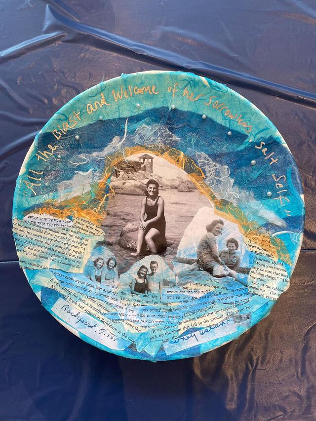 Plate with blue tissue paper, black and white portraits, and text