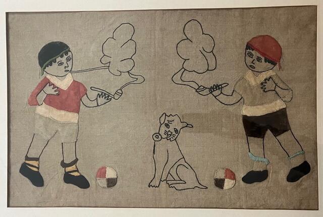 embroidery of a seated dog and two boys smoking cigars