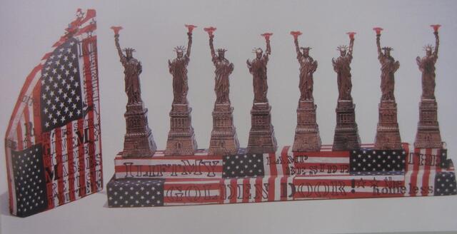 color photograph of a Hanukkah menorah constructed from Statue of Liberty figurines