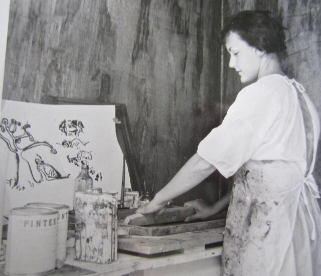 black and white image of a woman printmaking