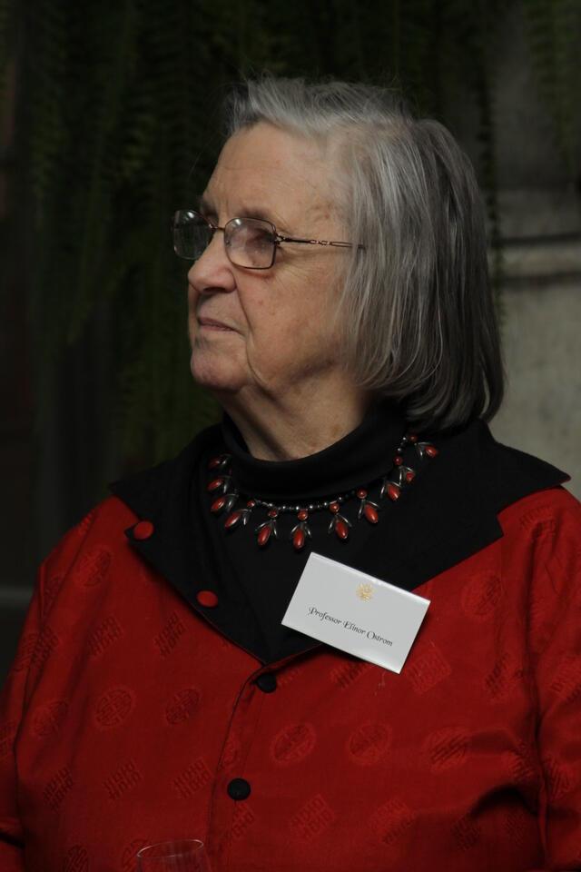 photograph of a woman with gray hair wearing a red dress