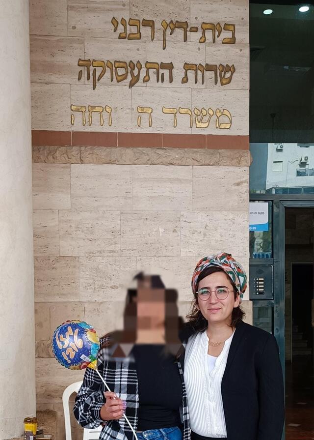 Woman with face blurred holding balloon next to another woman 