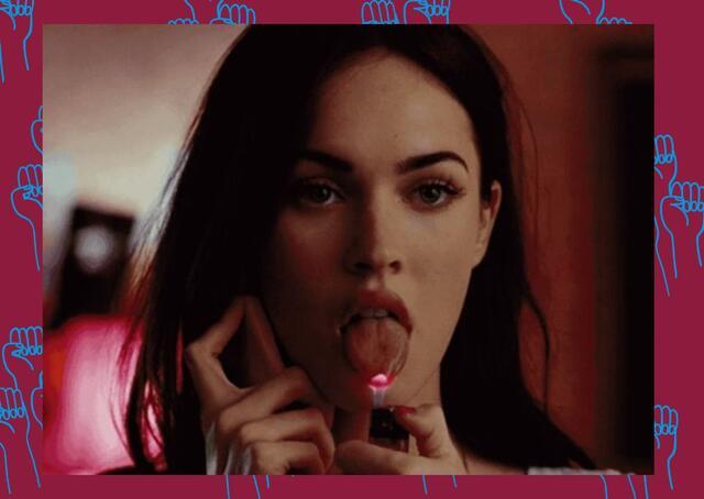 Megan Fox holding a flame to her tongue with her phone held up to her ear