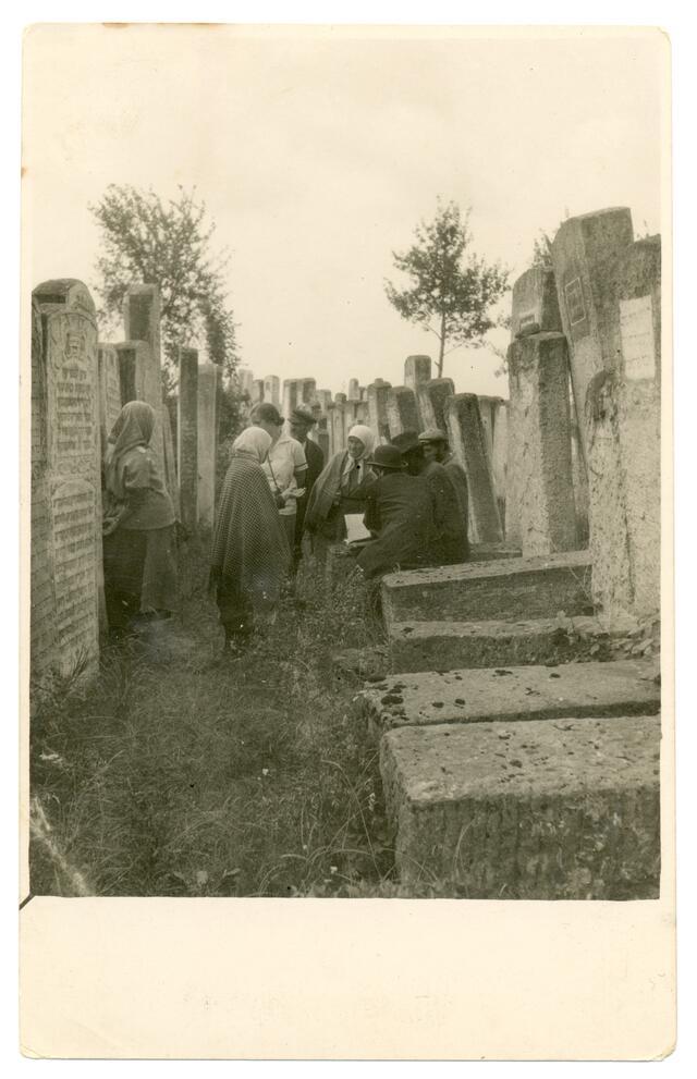 black and white historical photograph of professional mourning women in a cemetery