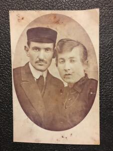 black and white photograph of a man in a hat and a woman